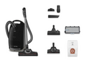Black vacuum cleaner with various attachments on a white background